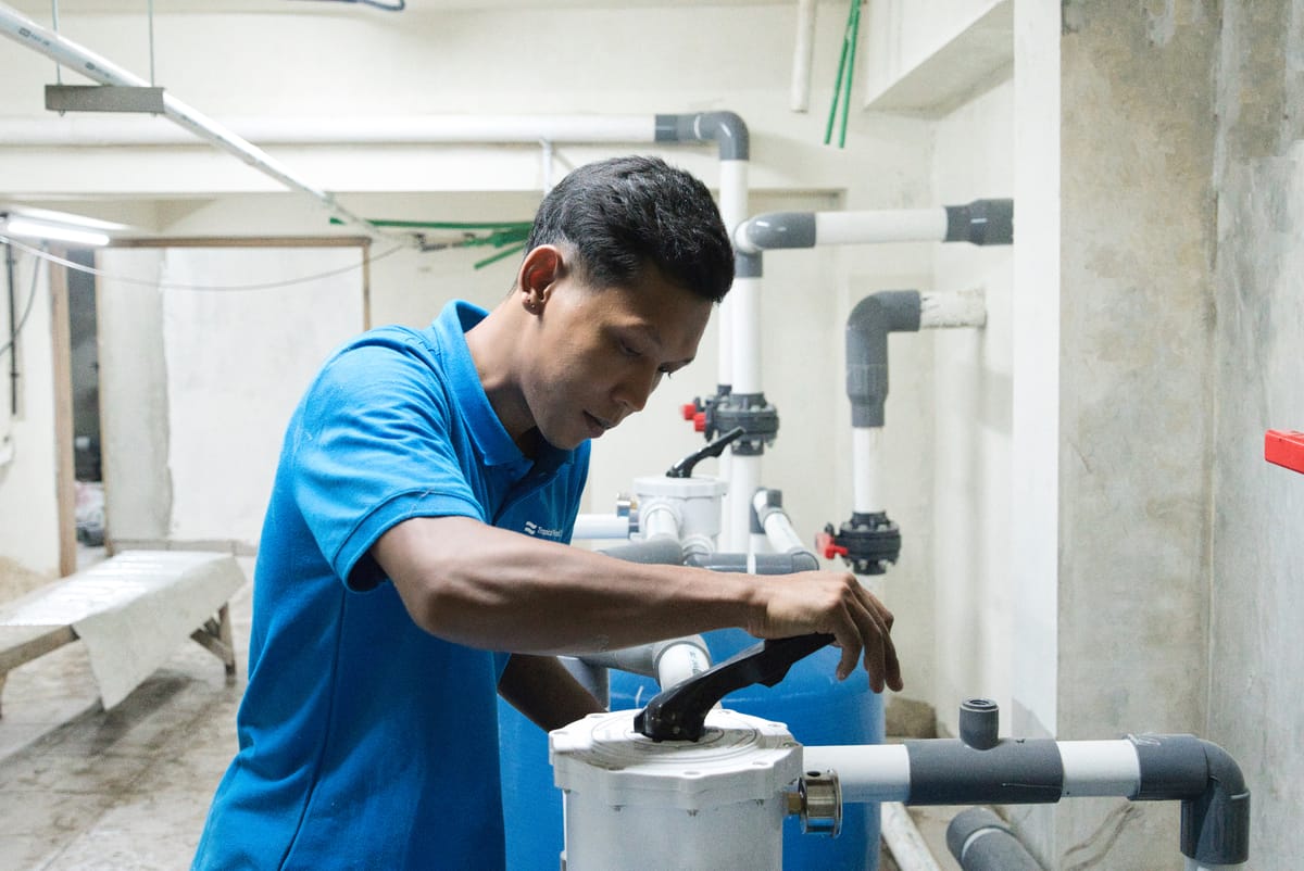 A Tropical Pool technician plumbing the pump and filtration plant room during a pool build in Bali