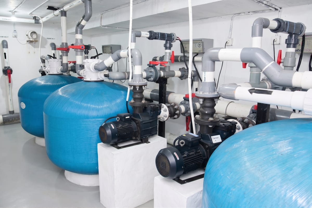 Pump and filter bank in a commercial pool plant room in Bali